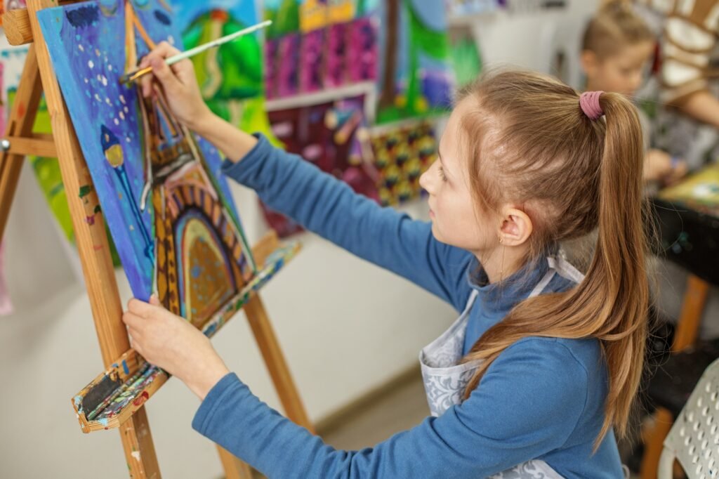 Focused Child Artist Painting on Canvas in Class